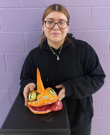 A person holding a sculpture